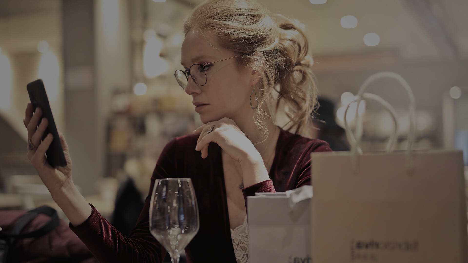 Woman looking at phone in restaurant